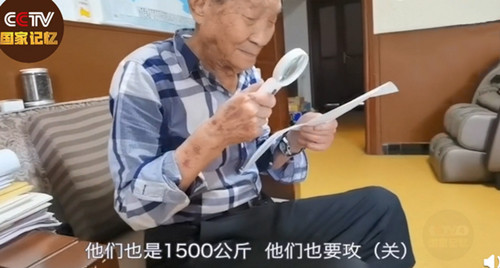 袁老通過放大鏡看文件